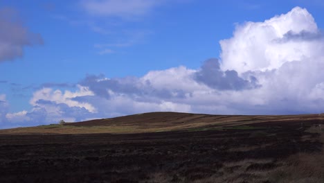 A-small-abandoned-stone-house-is-seen-in-the-distance-across-the-beautiful-Scottish-moors-1