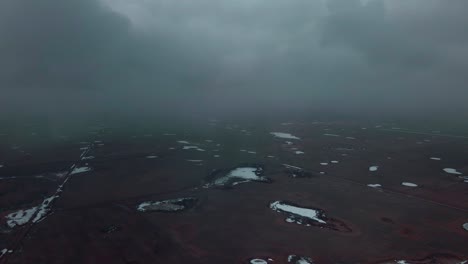 Drone-flying-through-clouds-above-wasteland