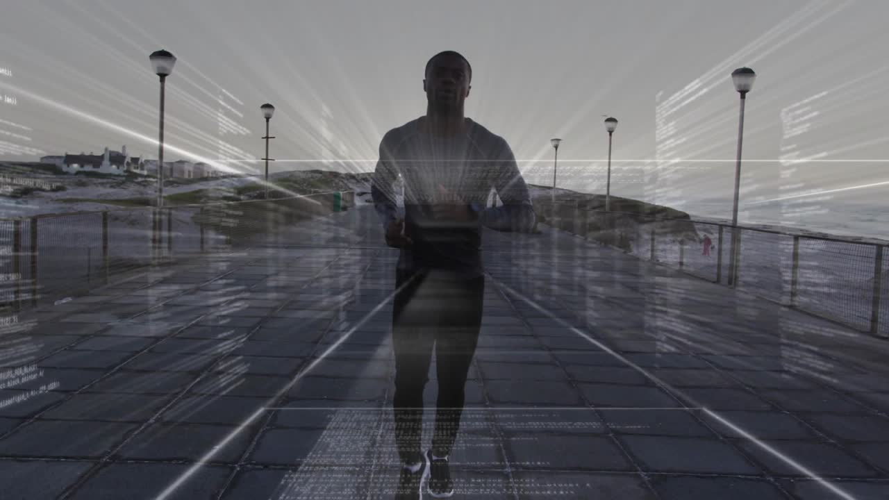 Mid-adult African American male running on coastal path in running gear holding device HUD overlay