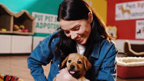 happy woman cuddling adorable puppy
