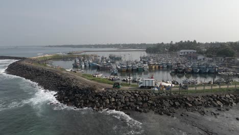 Low-flight-over-crowded-fishing-boat-marina-in-Hikkaduwa,-Sri-Lanka