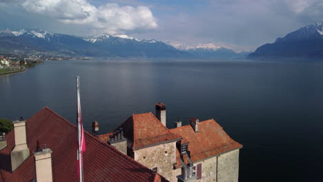 drone fly above the castle of rivaz and revealing the lake léman, vevey, montreux, in switzerland