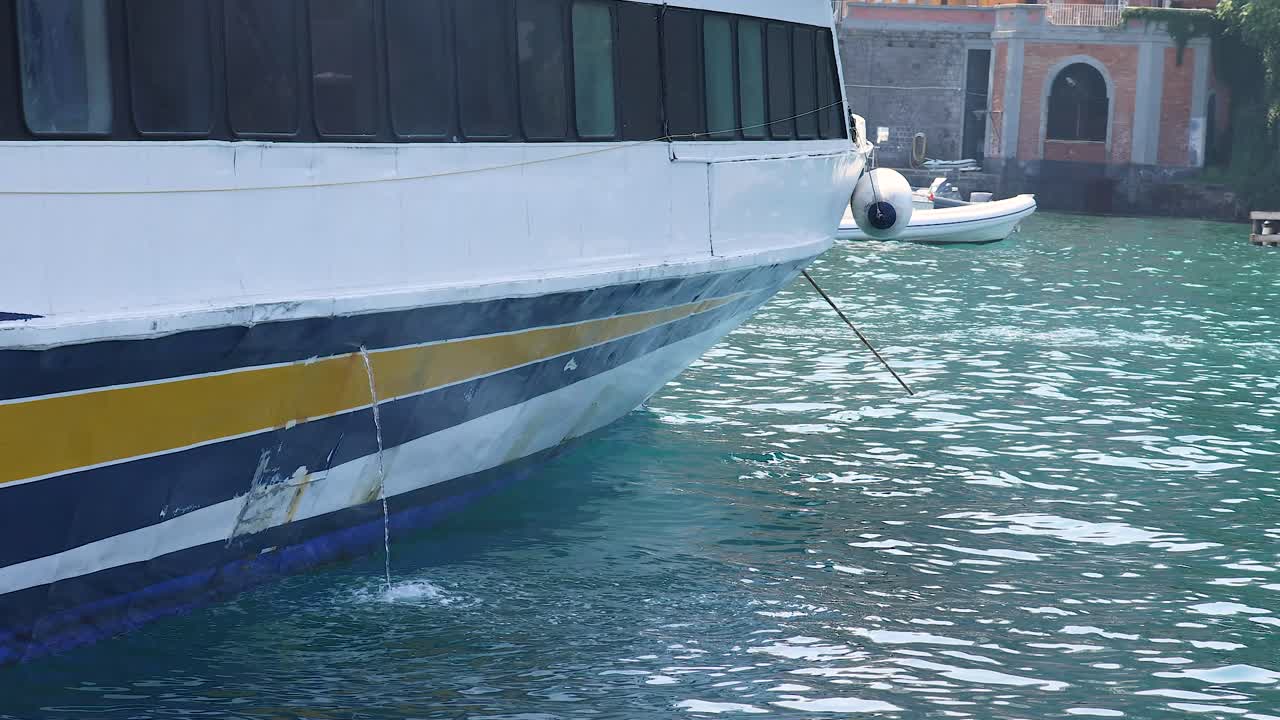 A boat approaches and docks at the pier