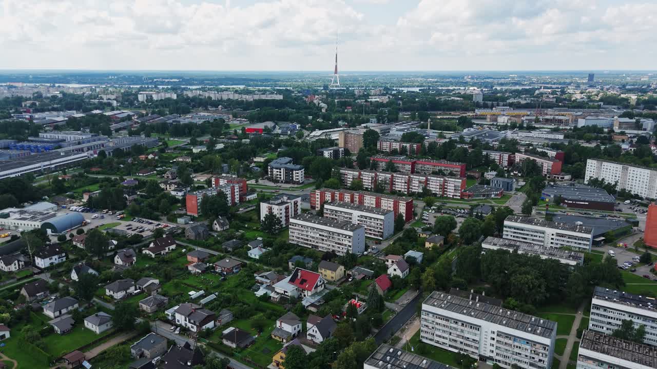 Smooth aerial dolly shot moves forward over Darzciems neighborhood with blocks and family homes