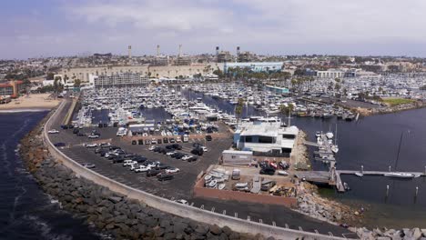 Aerial-low-panning-shot-of-the-King-Harbor-Yacht-Club-in-Redondo-Beach,-California