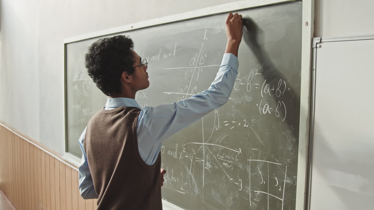 Mixed-Race Student Solving Geometry Problem at Blackboard