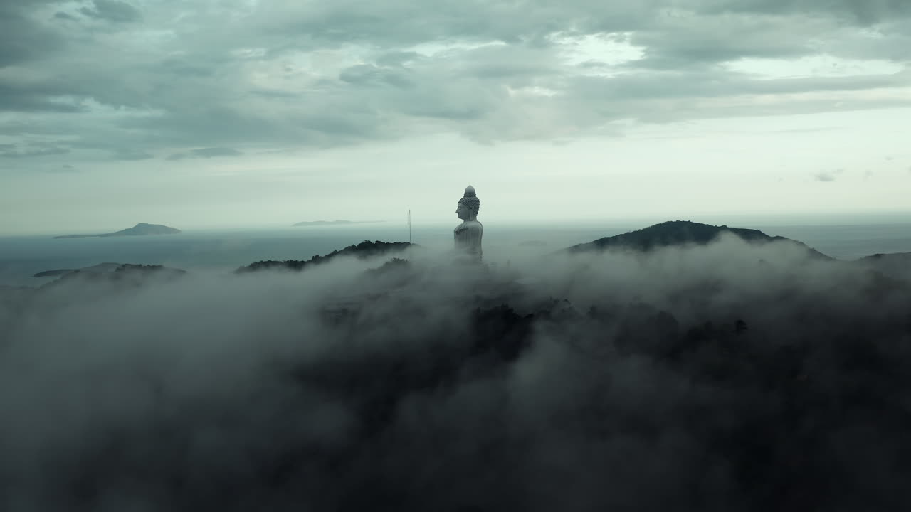 Giant Buddha Statue in Misty Mountains