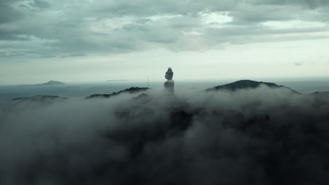 giant buddha statue in misty mountains