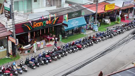 motorbikes parked outside shops and bars