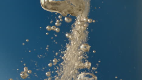 bubbles rising in water on blue background