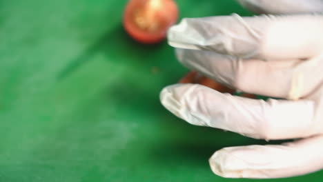 professional chef in a commercial kitchen cuts a tomato
