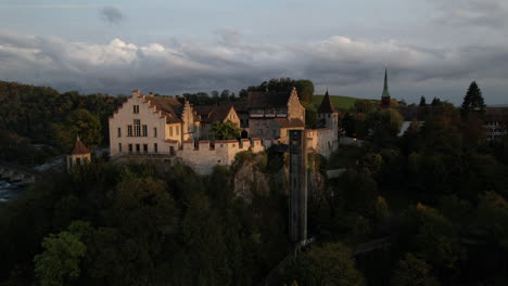 aerial shot in orbit over the castle of laufen
which is located on the mountain near the falls of the rhine