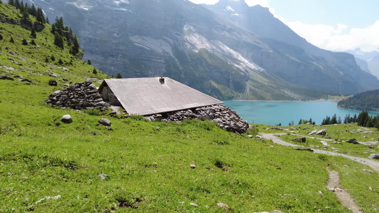 Touristic spot on the lake Oeschinen hike in Switzerland. Focus is on mountain restaurant