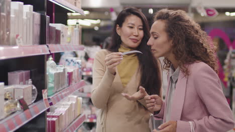 women discussing fragrance notes in beauty shop