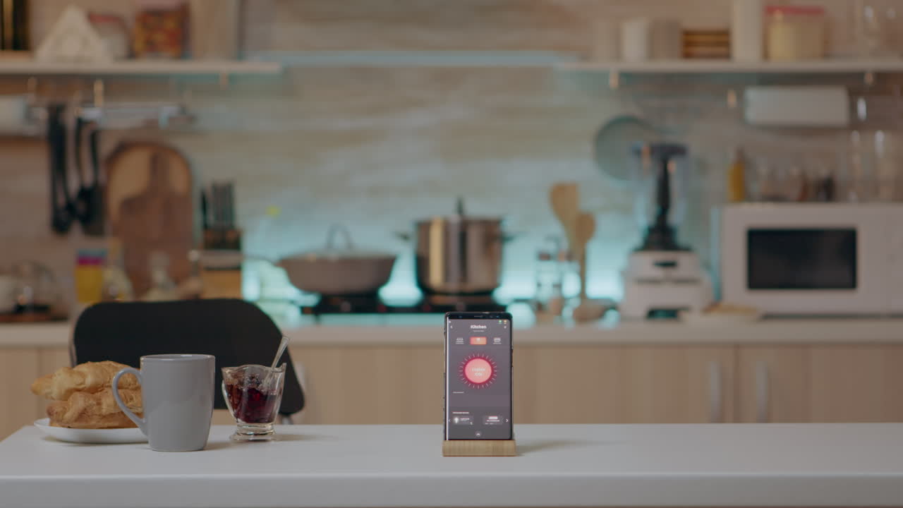 Phone with intelligent software placed on table in kitchen with nobody ...