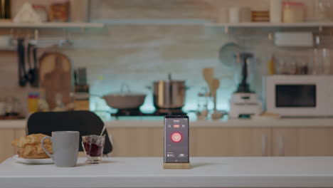 phone with intelligent software placed on table in kitchen with nobody in