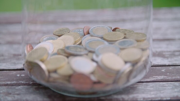 Various Euro coins with racked focus in big glass