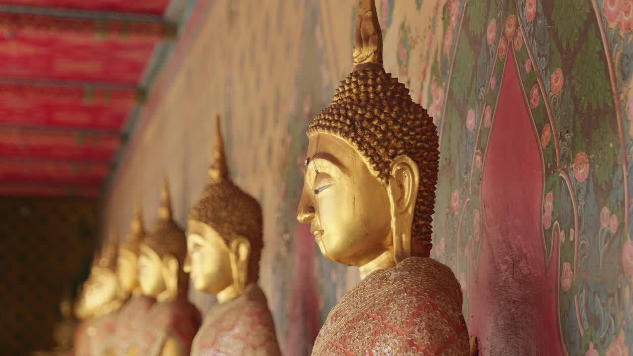 imágenes cinematográficas de viajes de 4k de estatuas doradas de buda y monjes en el templo del buda esmeralda wat phra kaew en bangkok, tailandia