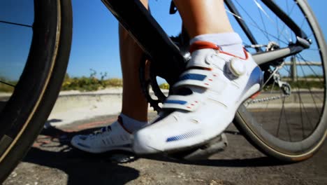 female cyclist cycling on a countryside road 4k