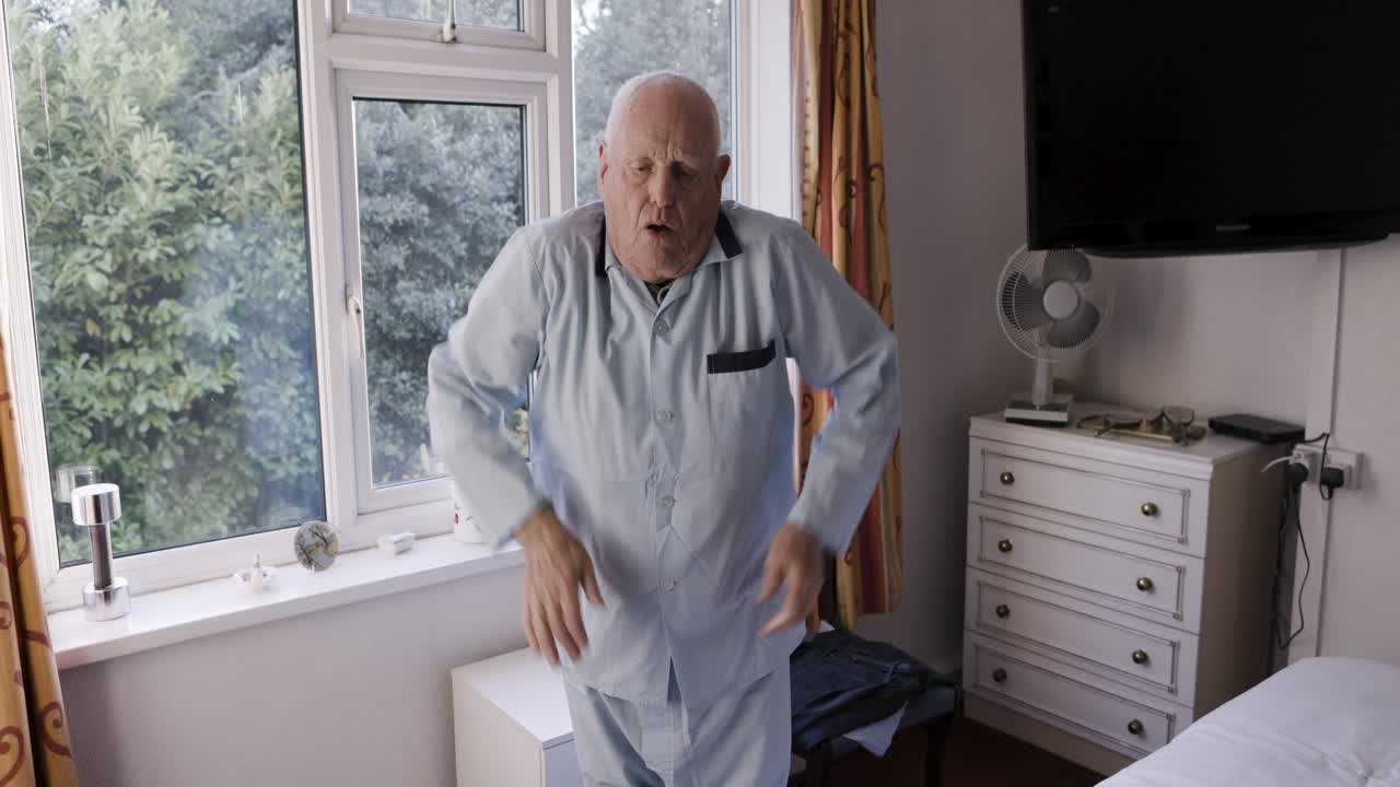 Elderly man in pajamas in bedroom