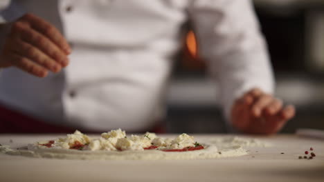 Chef-cooking-italian-pizza-in-restaurant.-Pastry-cook-preparing-traditional-food