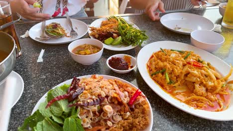 diverse seafood dishes shared at a table