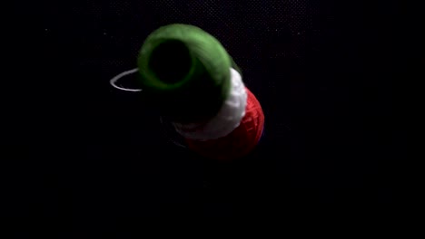 color-thread-spool-on-tower-fall-down-on-black-background-slow-motion