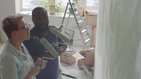 couple painting a wall