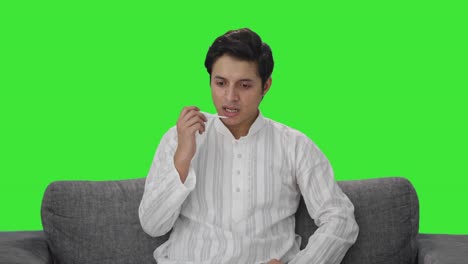 Indian-man-measuring-fever-using-thermometer-Green-screen