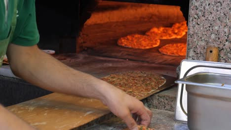 man preparing turkish flatbread in a kitchen