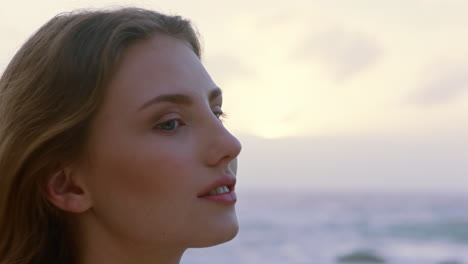 portrait of beautiful woman enjoying calm seaside at sunset exploring spirituality looking up praying contemplating journey relaxing on beach