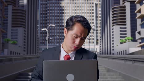 도시 에서 노트북 컴퓨터 를 사용 하는 동안 두통 을 고 있는 아시아 사업가