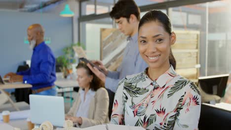 female executive holding architectural model in the office 4k