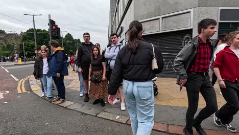 people crossing a busy street in edinburgh