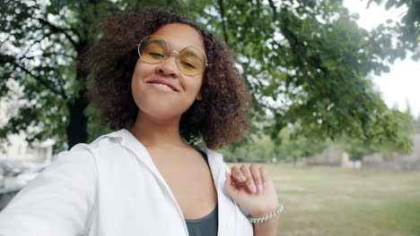 young woman taking a selfie in a park