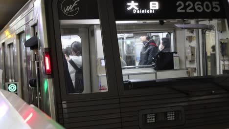 passengers at a busy subway station platform