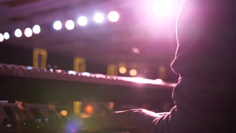 pianist playing piano at a theater in slowmotion