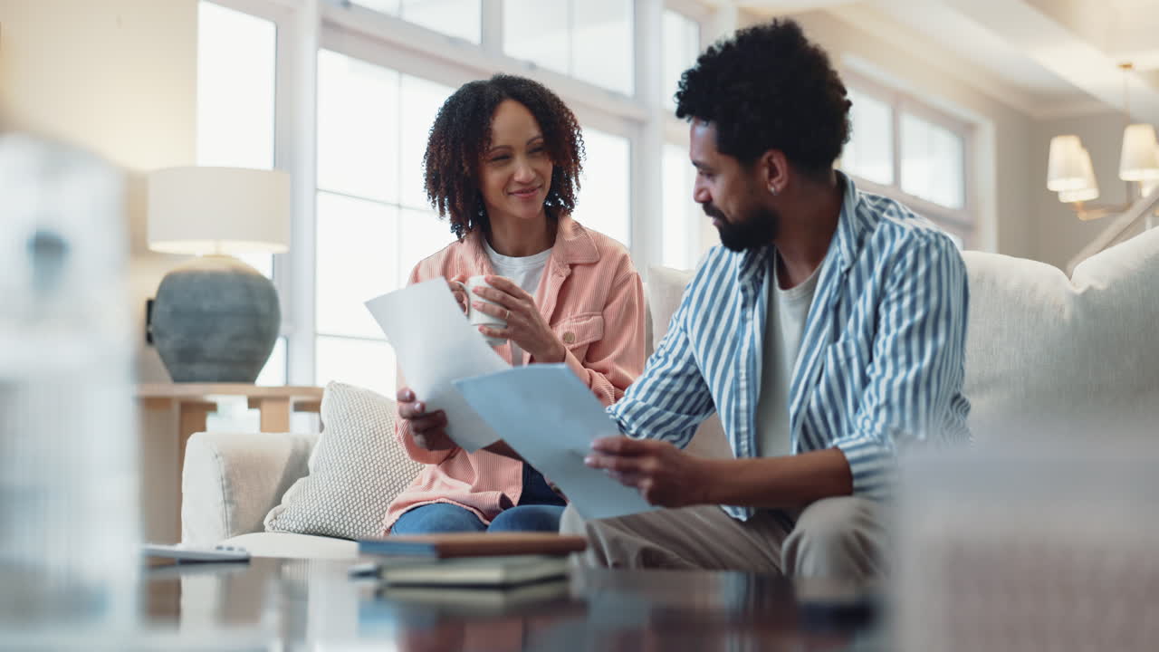 Happy Couple Reviewing Documents Together at Home