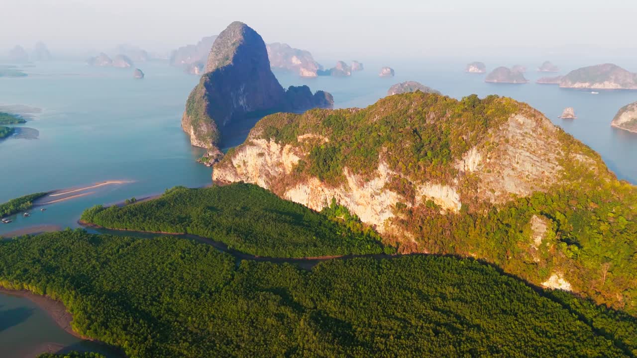 Beautiful Phang Nga Bay in Thailand Asia, slow drone orbit at sunrise.
