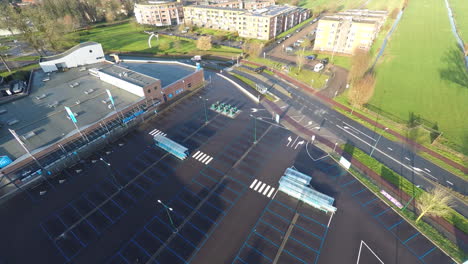 jib down of large empty parking lot in front of supermarket