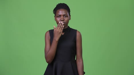 young beautiful african businesswoman looking shocked
