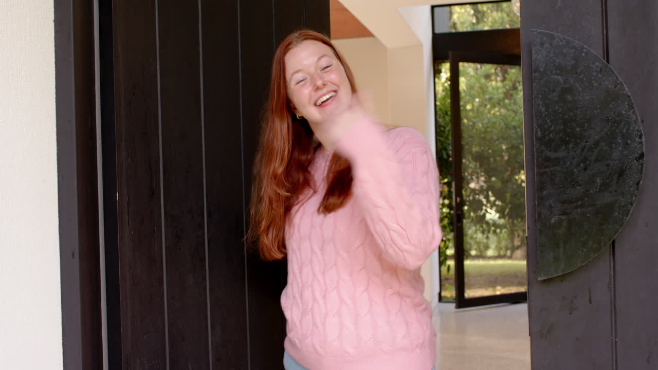 Smiling woman welcoming female friends at front door, enjoying casual hangout, copy space