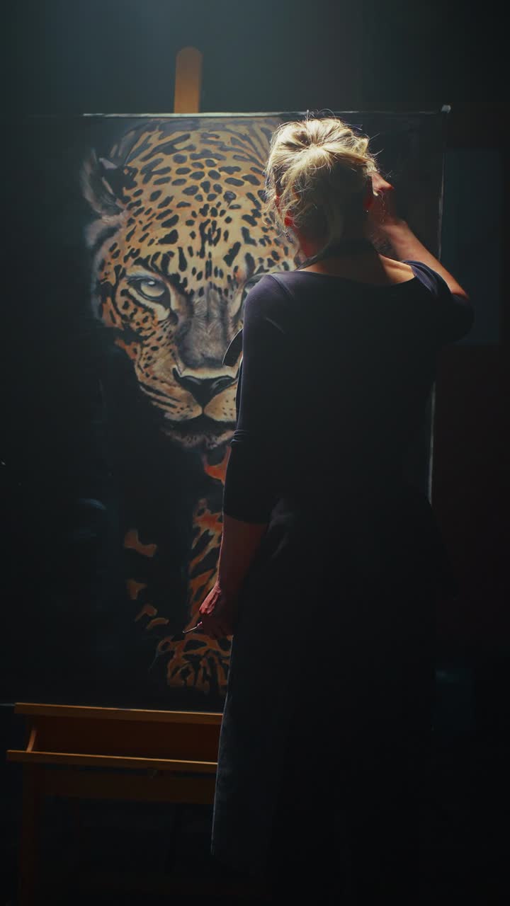 Woman Artist Painting a Leopard Portrait in a Studio