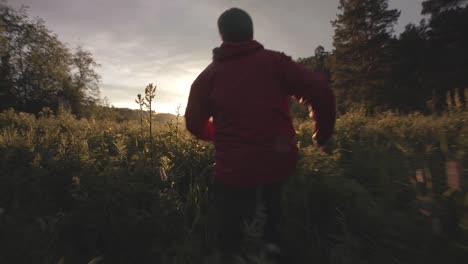 man running through a forest at sunrise