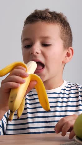 child eating a banana