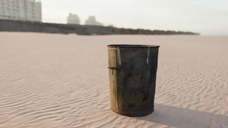 gray metal garbage bin or trash can on the beach