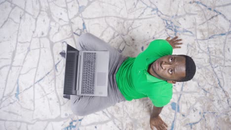unhappy and unsuccessful african young man using laptop.