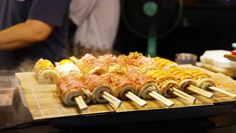 grilled skewers cooking at bustling night market