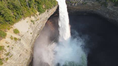 helmcken falls rushing over a cliffs edge into the murtle river in wells gray provincial park in british columbia, canada