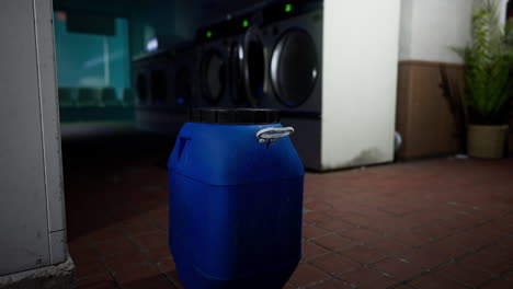 a blue container in a laundry room